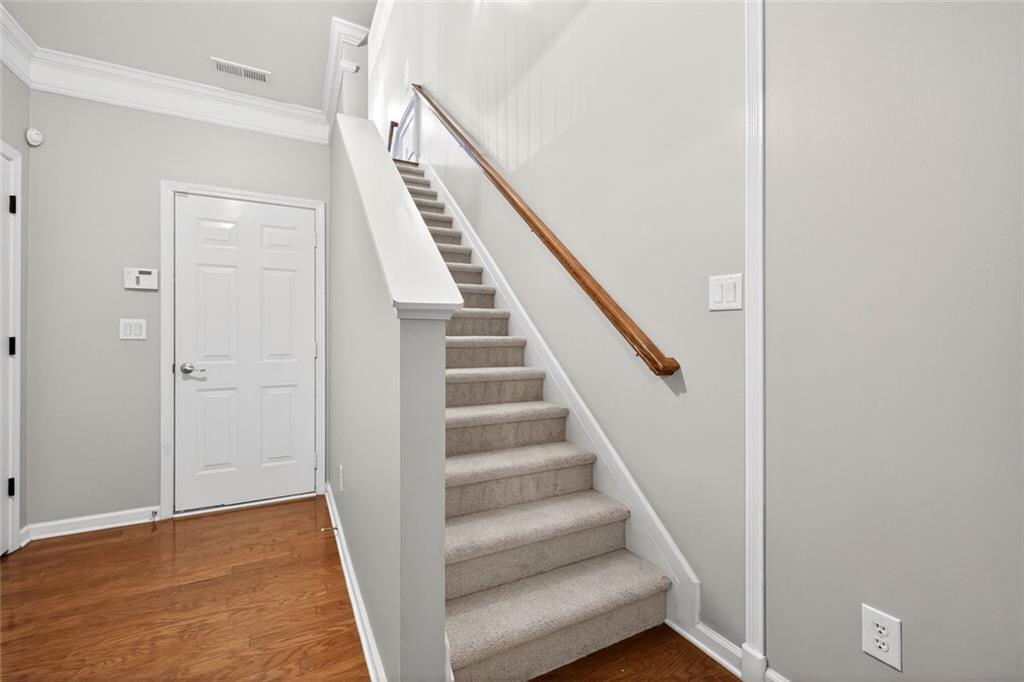 1982 Cobblestone Circle Northeast Brookhaven, GA 30319 - Photo 30 of 51 a view of staircase with wooden floor and white walls