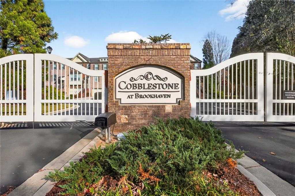 1982 Cobblestone Circle Northeast Brookhaven, GA 30319 - Photo 3 of 51 a view of a sign board with stairs and a street view