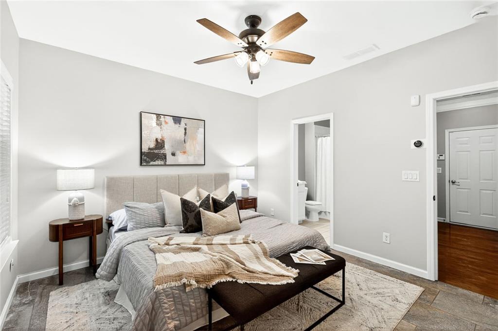 1982 Cobblestone Circle Northeast Brookhaven, GA 30319 - Photo 32 of 51 a bedroom with a bed and ceiling fan