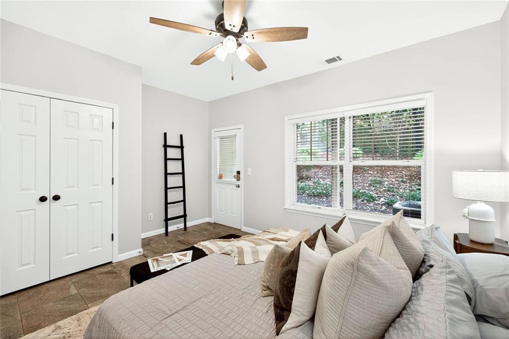 1982 Cobblestone Circle Northeast Brookhaven, GA 30319 - Photo 33 of 51 a bedroom with a large bed and a window