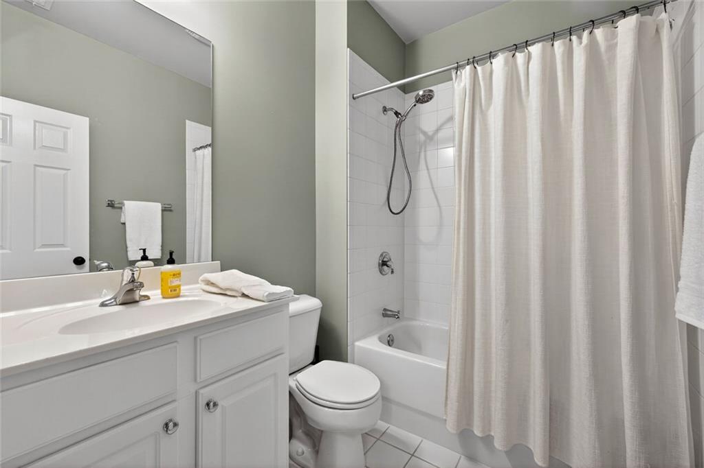 1982 Cobblestone Circle Northeast Brookhaven, GA 30319 - Photo 34 of 51 a bathroom with a sink a toilet and shower curtain