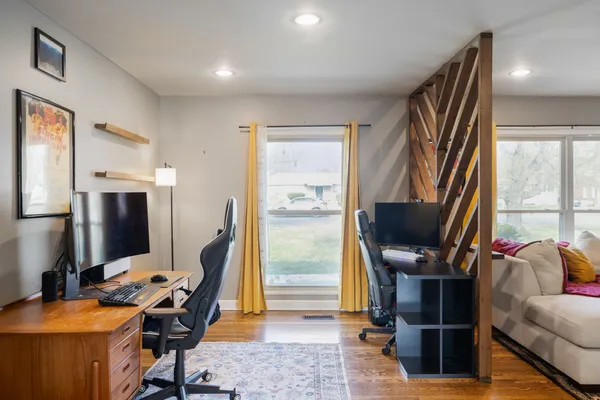a view of a workspace with furniture and a window