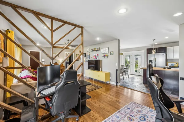 a living room with lots of furniture and a wooden floor