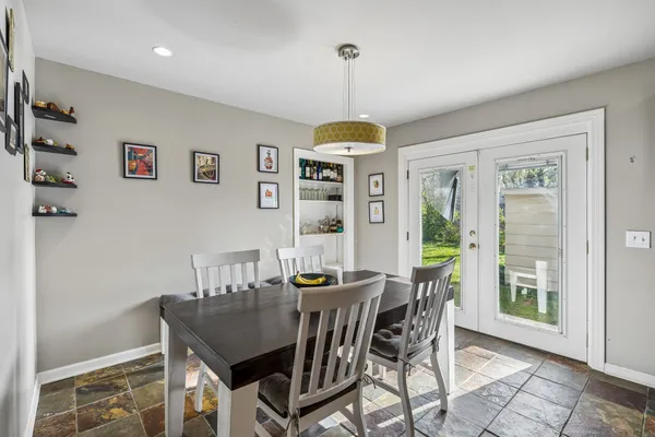 a dining room with furniture a chandelier and window