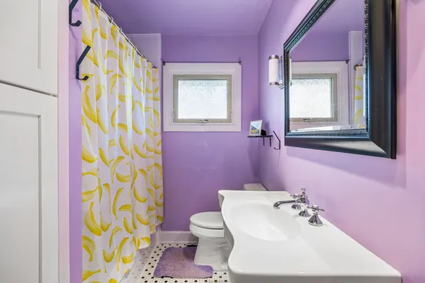 a bathroom with a sink toilet and mirror