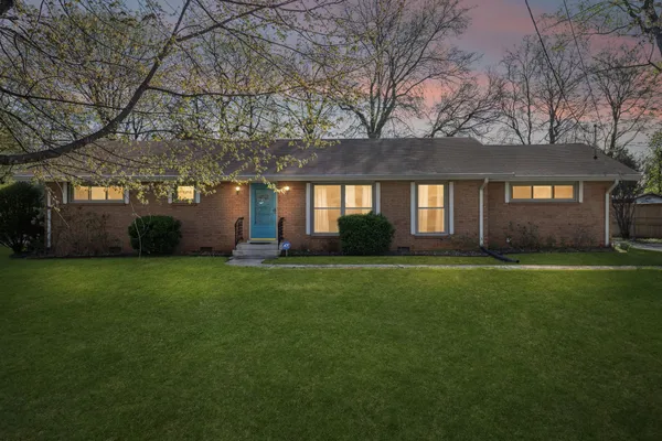 a front view of house with yard and green space