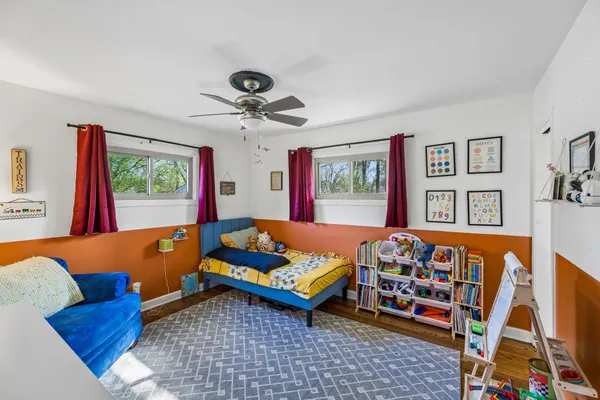 a living room with blue furniture and a flat screen tv