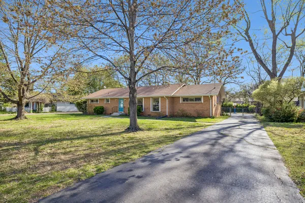 a yellow house sitting in middle of forest