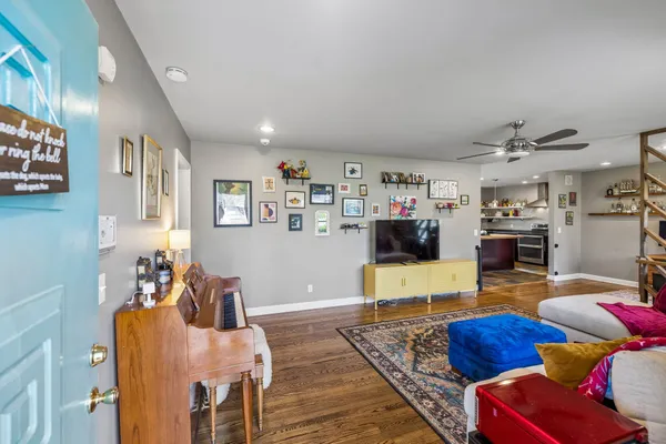a living room with furniture and wooden floor