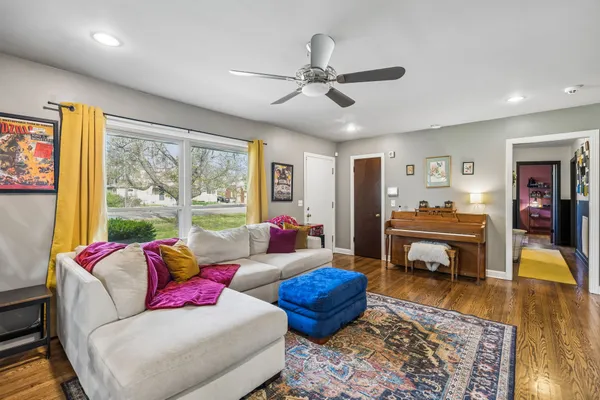 a living room with furniture and a wooden floor