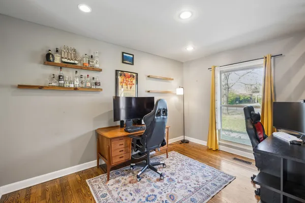 a view of a workspace with furniture and a window