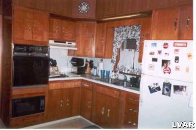 2220 Village Road Orefield, PA 18069 - Photo 7 of 10 a kitchen with a refrigerator and a stove