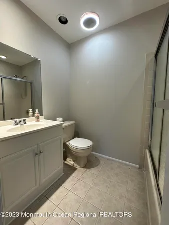 a bathroom with a sink a toilet and a mirror
