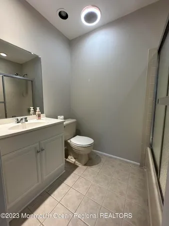 a bathroom with a sink a toilet and a mirror