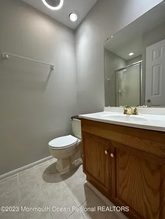a bathroom with a sink a toilet and a mirror