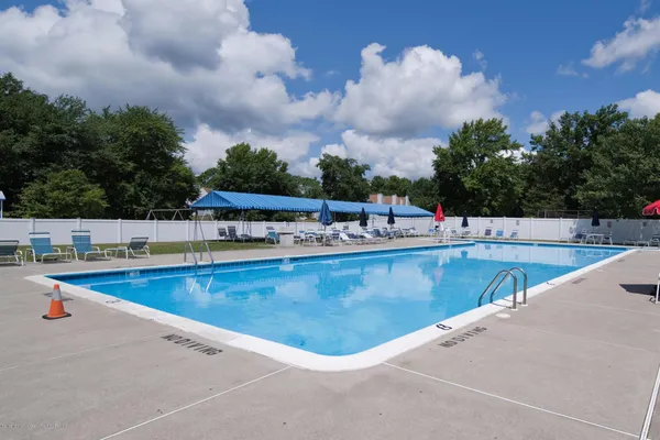 a view of a swimming pool with outdoor seating