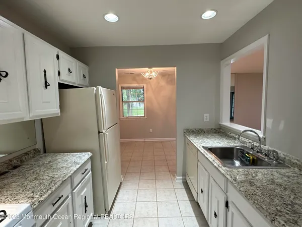 a kitchen with a sink stove and refrigerator