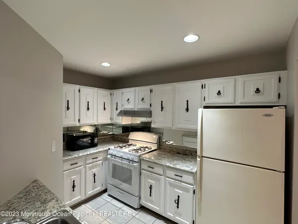 a kitchen with stainless steel appliances a refrigerator sink and cabinets