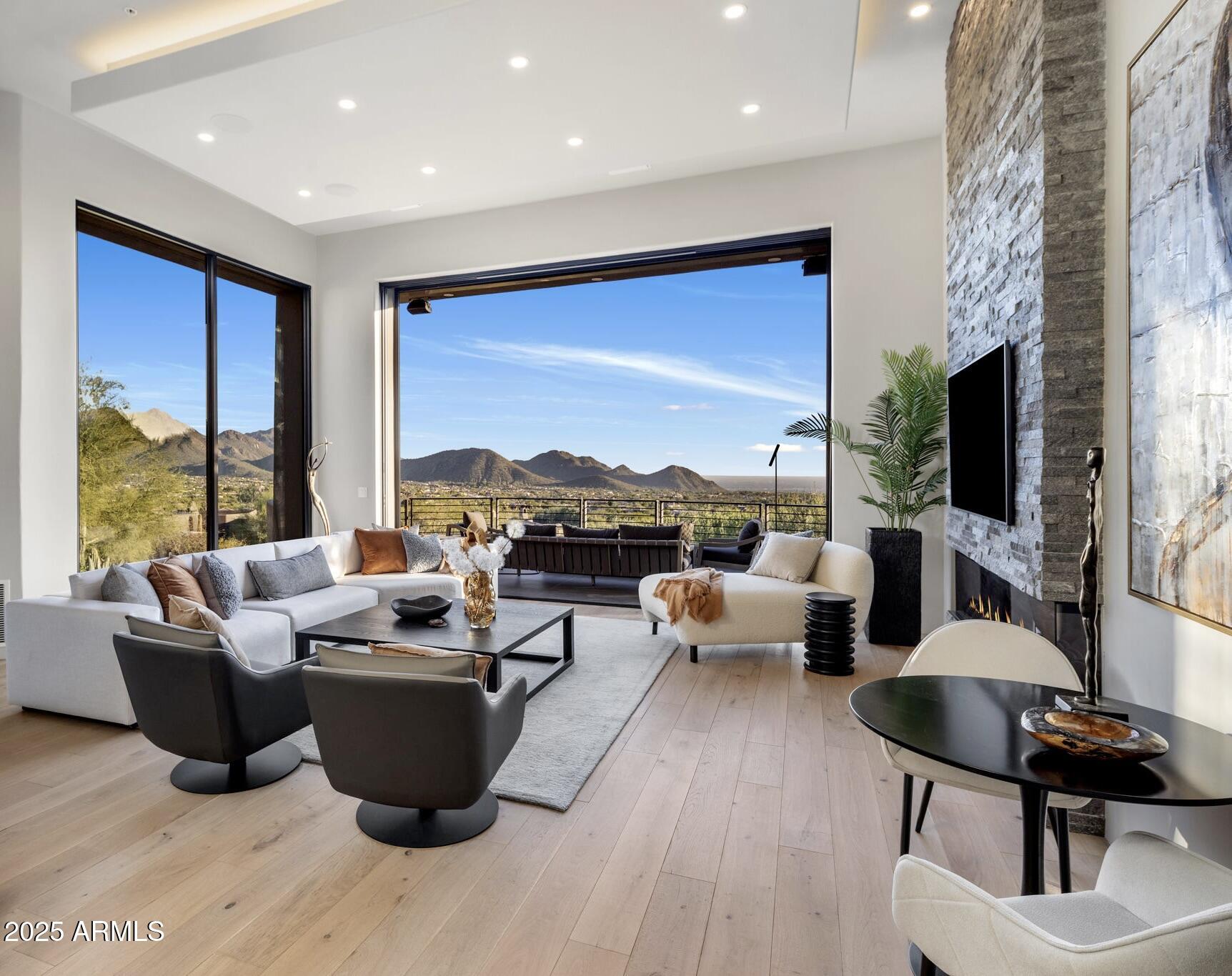 10040 East Happy Valley Road, Unit 1039 Scottsdale, AZ 85255 - Photo 1 of 60 a living room with fireplace furniture and a flat screen tv