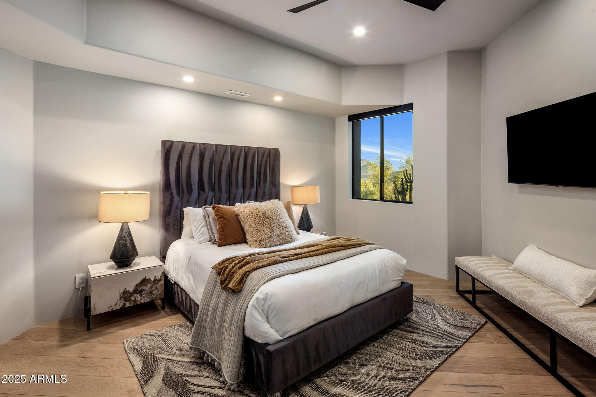 10040 East Happy Valley Road, Unit 1039 Scottsdale, AZ 85255 - Photo 32 of 60 a bedroom with bed and a flat screen tv