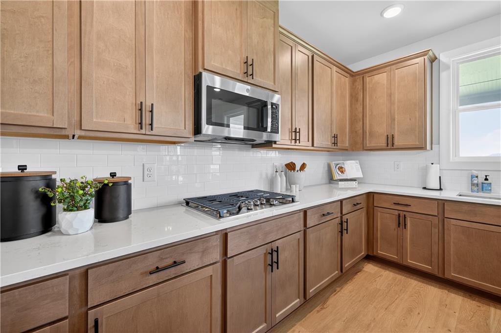 2541 Parkside Way Gainesville, GA 30507 - Photo 11 of 45 a kitchen with cabinets and white appliances
