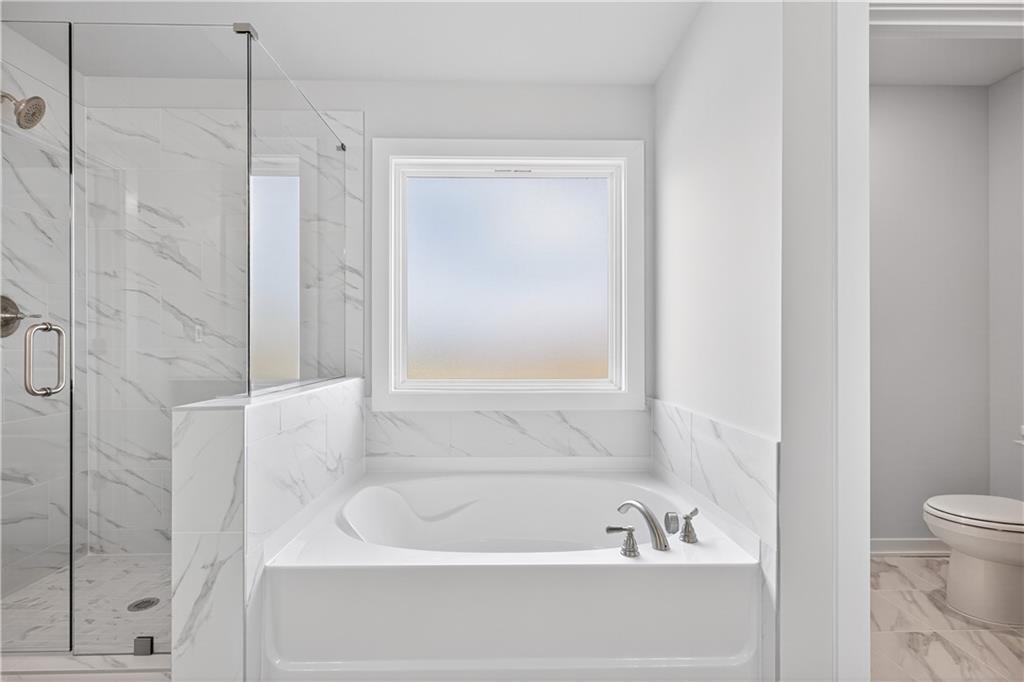 2541 Parkside Way Gainesville, GA 30507 - Photo 38 of 45 a bathroom with a bathtub and a shower