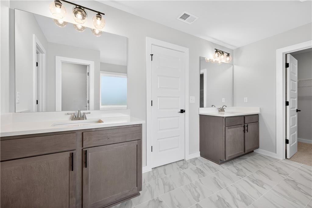 2541 Parkside Way Gainesville, GA 30507 - Photo 40 of 45 a bathroom with a sink vanity granite tub and a mirror
