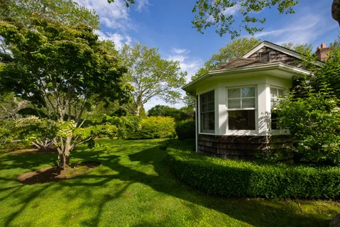 a view of a house with a small yard and a fountain