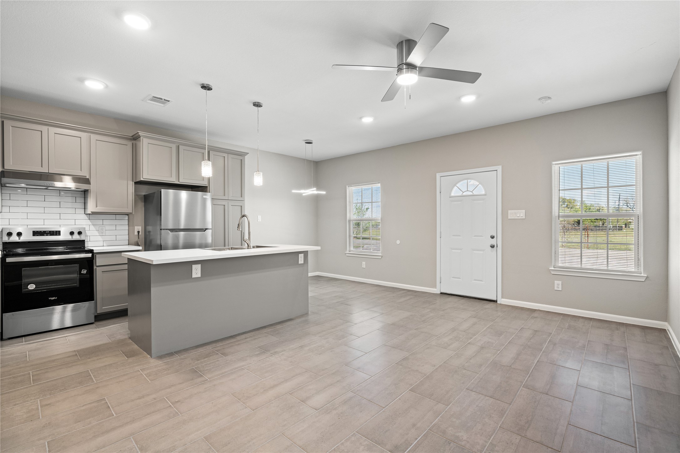142 Calloway Street, Unit A Houston, TX 77029 - Photo 11 of 23 a large kitchen with kitchen island a sink stainless steel appliances and cabinets