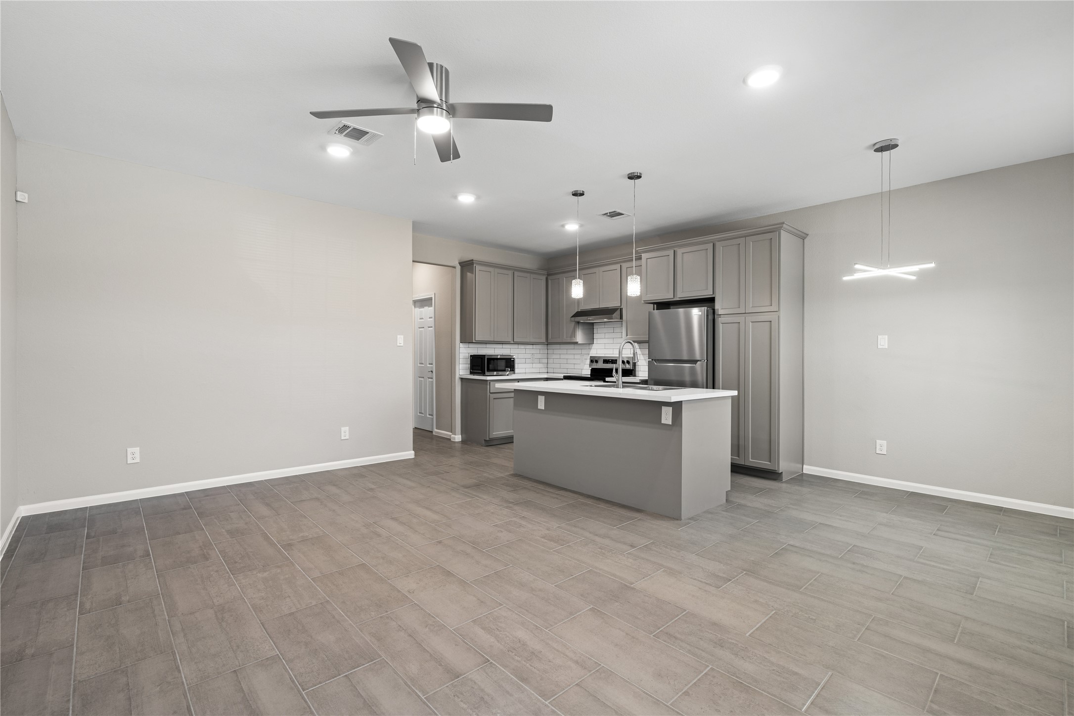 142 Calloway Street, Unit A Houston, TX 77029 - Photo 5 of 23 a view of kitchen with kitchen island stainless steel appliances sink cabinets and window