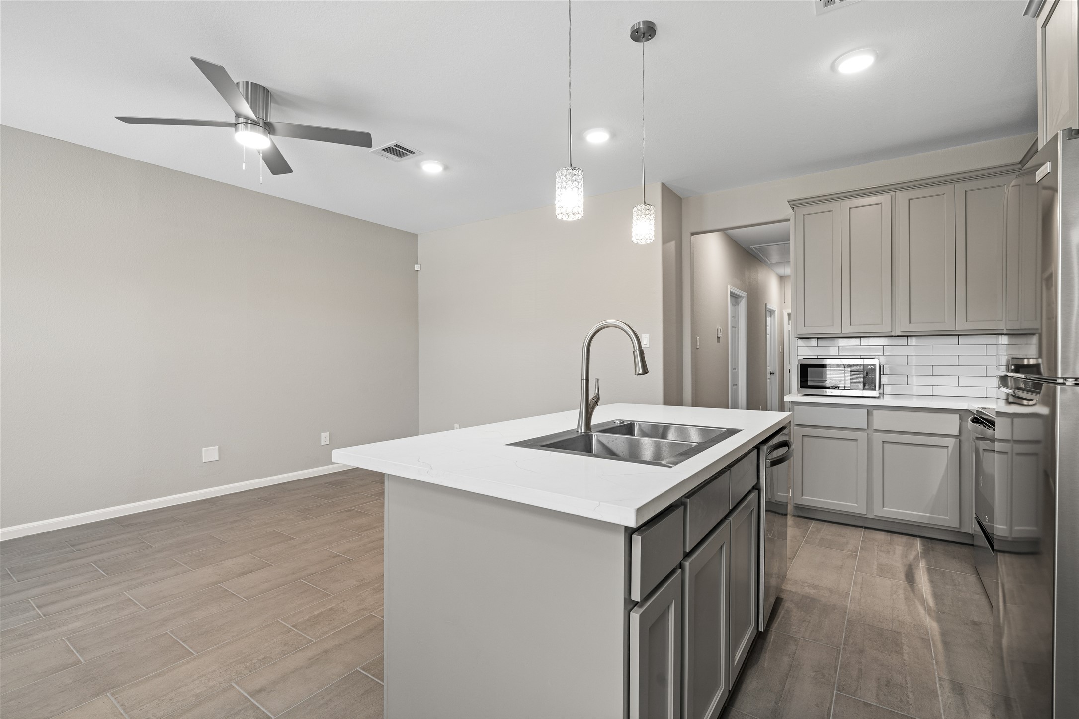 142 Calloway Street, Unit A Houston, TX 77029 - Photo 8 of 23 a kitchen with a sink dishwasher and white cabinets with wooden floor