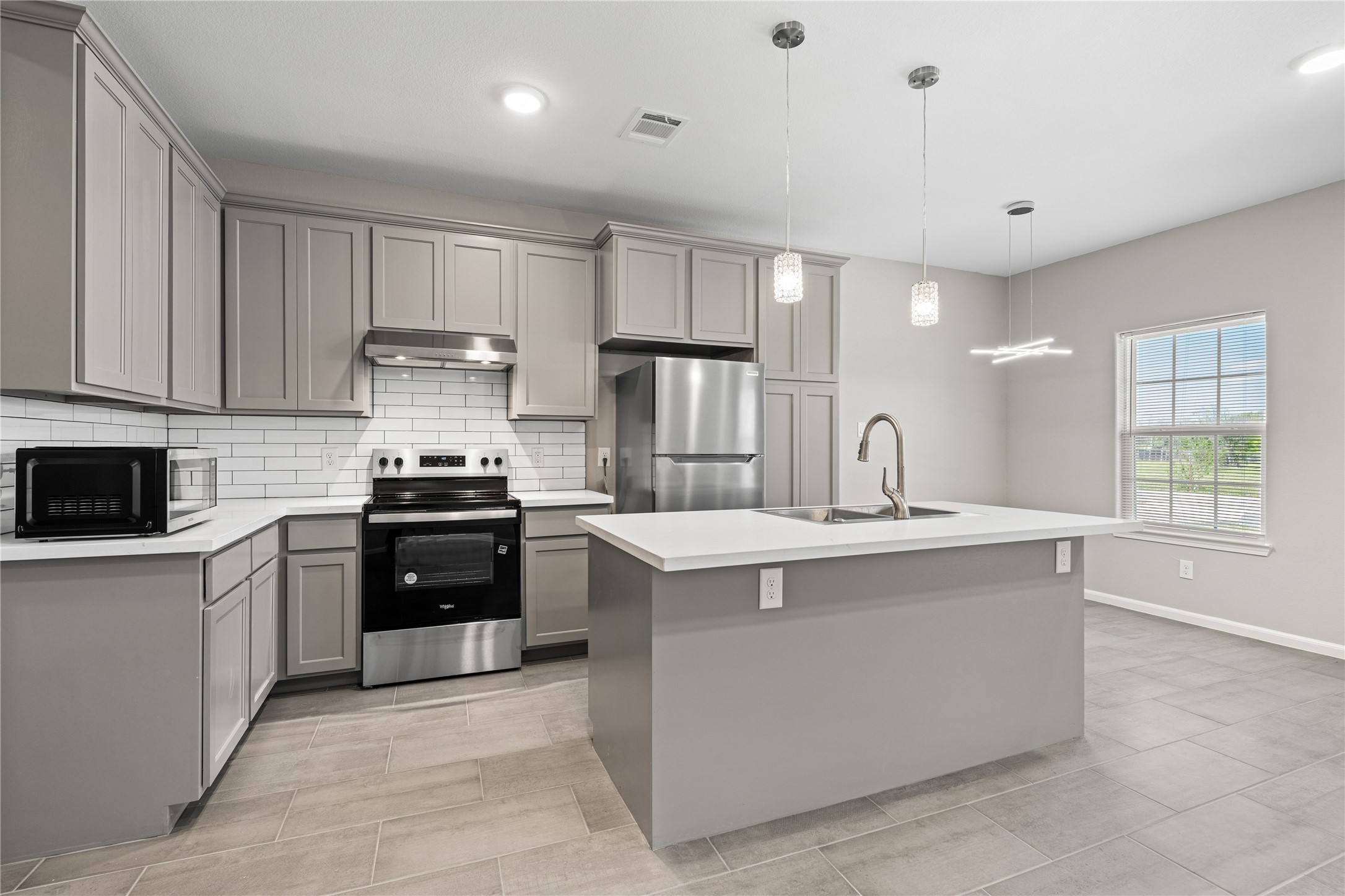 142 Calloway Street, Unit A Houston, TX 77029 - Photo 9 of 23 a kitchen with stainless steel appliances a sink stove and refrigerator
