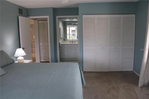 a bedroom with a bed and a lamp