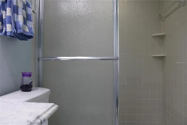 a bedroom with a bed and lamp