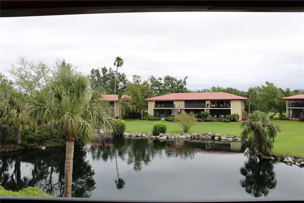 a view of a lake with a house in the background
