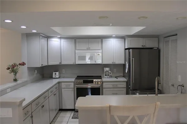 a kitchen with a sink cabinets and stainless steel appliances
