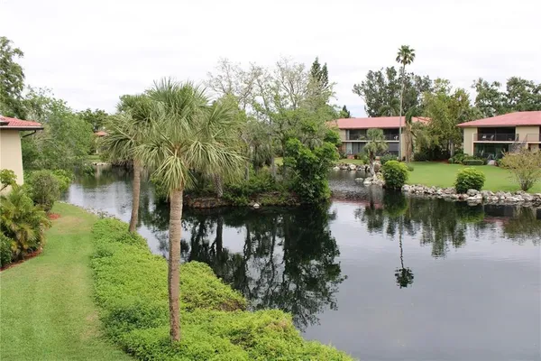 a view of a house with backyard garden and swimming pool