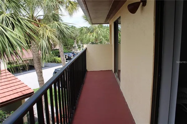 a view of a balcony with wooden floor