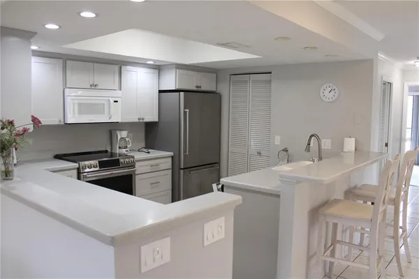 a kitchen with stainless steel appliances a refrigerator sink and stove