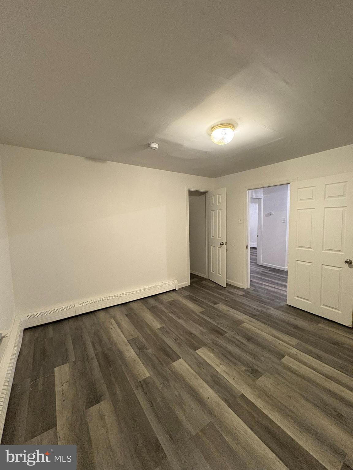 38 Broadway, Unit C Laurel Springs, NJ 08021 - Photo 11 of 15 an empty room with wooden floor and windows
