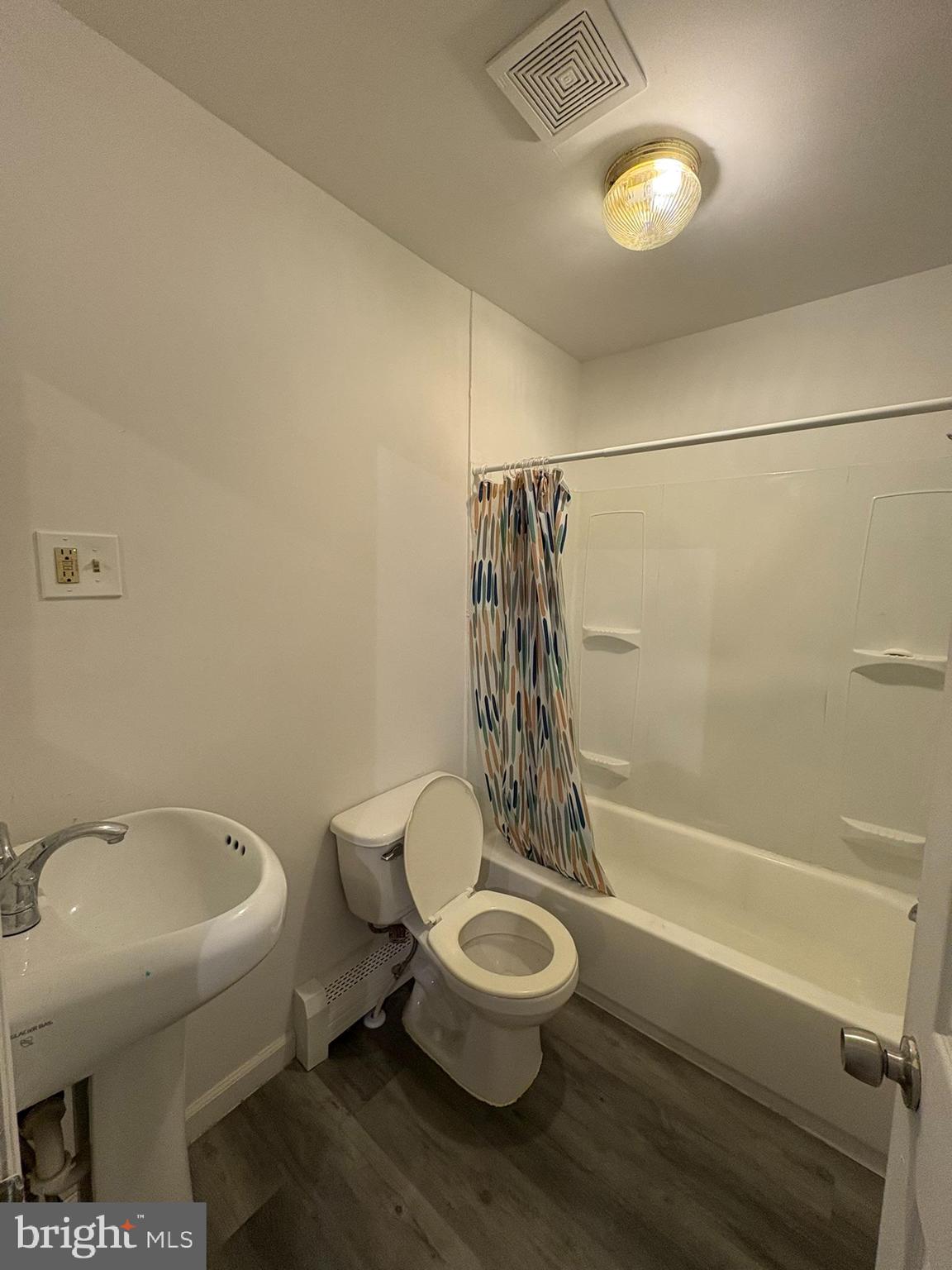 38 Broadway, Unit C Laurel Springs, NJ 08021 - Photo 4 of 15 a white toilet sitting next to a bath tub