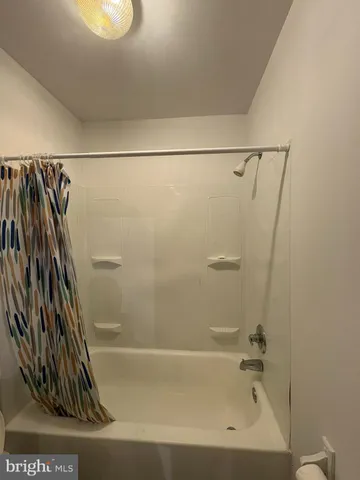 a bathroom with a shower and a glass door