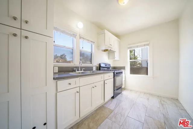a large bathroom with a granite countertop sink