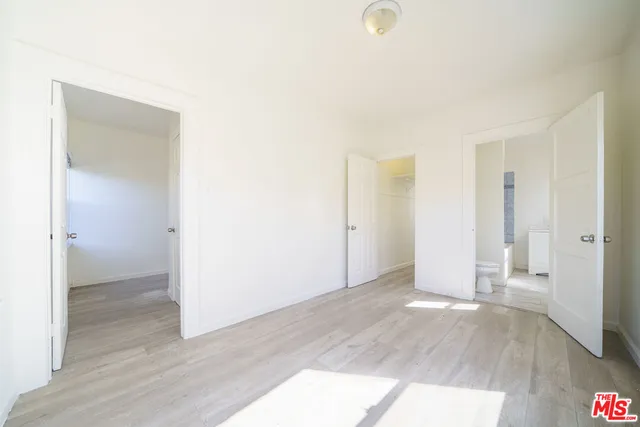 a view of an empty room and wooden floor