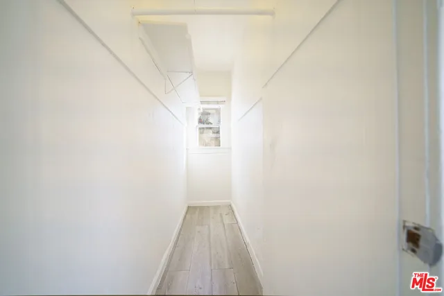 a view of a room with wooden floor