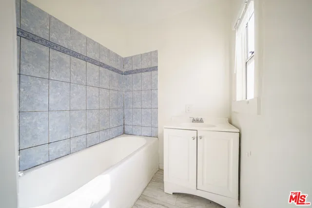 a bathroom with a bathtub and shower