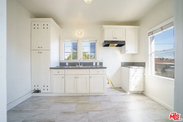 a kitchen with stainless steel appliances a refrigerator sink and cabinets