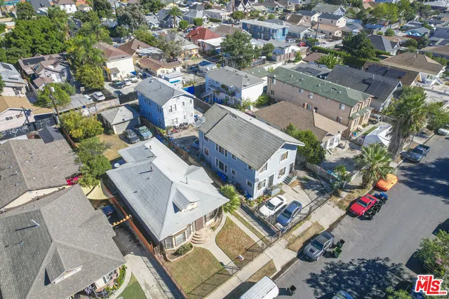 an aerial view of a residential houses with street