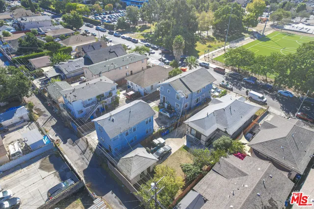 an aerial view of multiple houses with yard