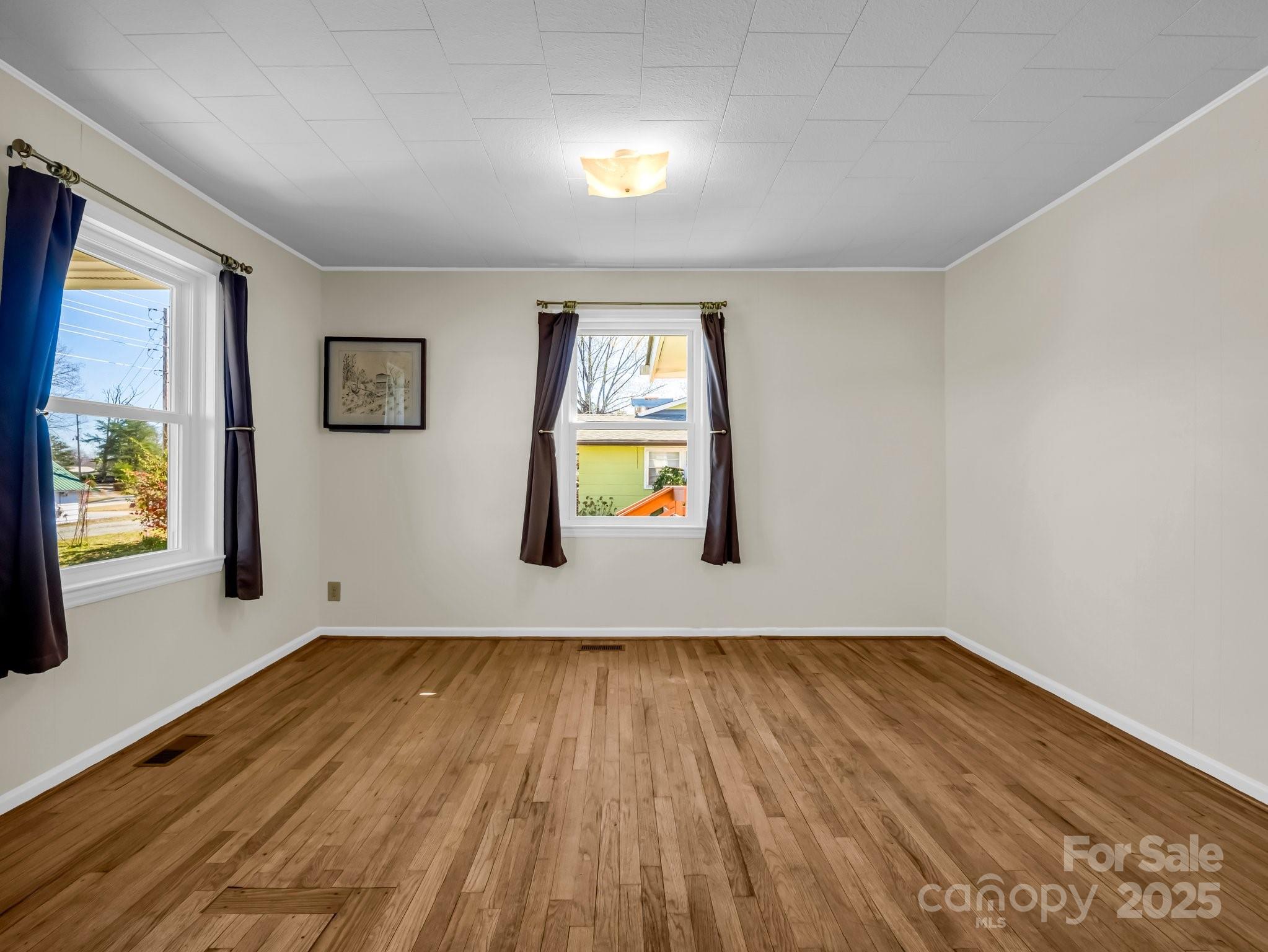 34 Manus Chapel Road Mill Spring, NC 28756 - Photo 13 of 42 a view of empty room with wooden floor and fan